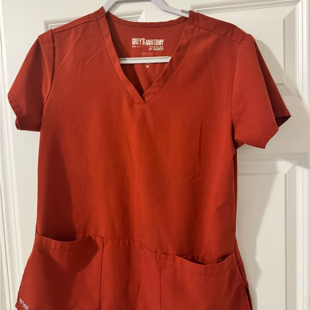 Grey's Anatomy Women's Short Sleeve Top in brick color.